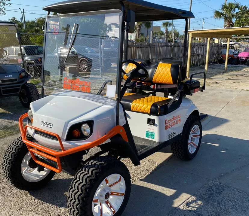 White lifted golf cart with orange and black seats